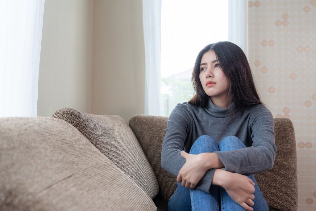 unhappy-asian-pretty-young-woman-siting-alone-couch-with-feeling-sadness.jpg